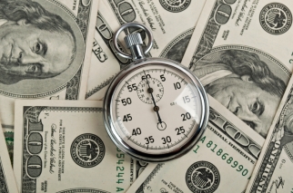 american dollars and stopwatch